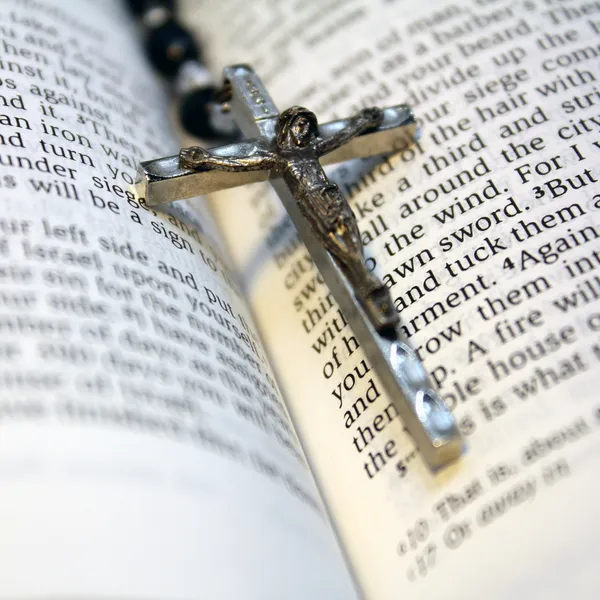 A rosary laying on a bible